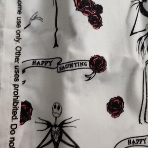 May include: White fabric with a repeating pattern featuring Jack Skellington figures, red roses, and banners that read "HAPPY HAUNTING." The fabric also includes text that reads "Sold for noncommercial home use only."