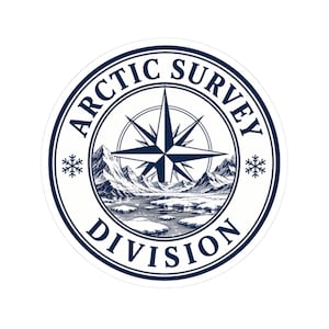 May include: A circular sticker featuring a dark blue border with the text ARCTIC SURVEY DIVISION. The center displays a compass rose above a detailed illustration of snowy mountains and icy water, flanked by two small snowflake icons on each side.