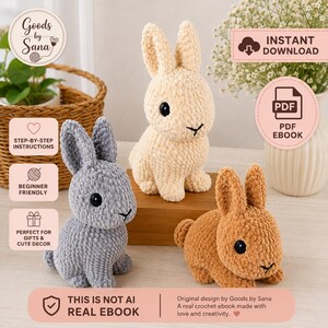 May include: Three crocheted plush rabbits in beige, gray, and brown, each featuring black safety eyes and stitched noses. The image includes text labels: Goods by Sana, Instant Download, PDF Ebook, Step-by-step instructions, Beginner friendly, Perfect for gifts & cute decor, and This is not AI real ebook.