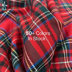 Op de afbeelding: Close-up van rode tartan stof met een ruitpatroon. De stof heeft een mix van rode, zwarte, groene, witte en blauwe lijnen. Tekst in de afbeelding luidt "50+ Colors In Stock" en "The Scottish Touch".