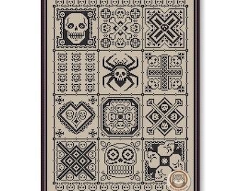 May include: A framed cross-stitch sampler featuring a grid of black and white spooky designs. The designs include skulls, spiders, and geometric patterns. The sampler is in a dark brown frame.