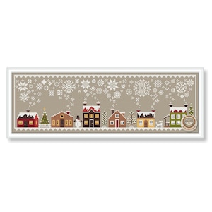 May include: A cross-stitch pattern of a winter village scene. The design features several houses in various colors, a snowman, and a Christmas tree. Snowflakes are falling in the background. The artwork is framed in a white border.