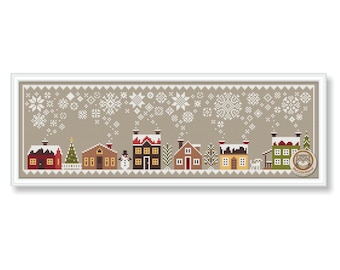 May include: A cross-stitch pattern of a winter village scene. The design features several houses in various colors, a snowman, and a Christmas tree. Snowflakes are falling in the background. The artwork is framed in a white border.