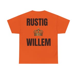 May include: Orange t-shirt with the text "RUSTIG WILLEM" in black block letters. A gold-colored crown graphic is centered between the words. The shirt is a solid orange color.