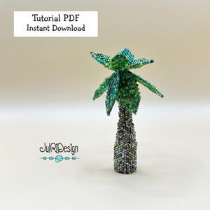 May include: A beaded palm tree sculpture with a textured trunk and green fronds. The text "Tutorial PDF Instant Download" is displayed at the top. The sculpture is a unique handmade item.