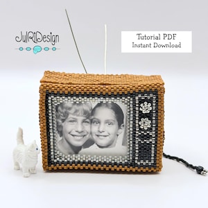 May include: A handmade beaded miniature television with a black and white photo inside. The TV is brown, black, and silver, with the text "Tutorial PDF Instant Download". A small white cat figurine is next to the TV.