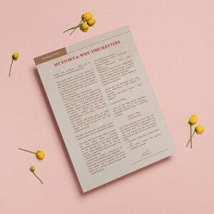 May include: A printed document with the title "MY STORY & WHY THIS MATTERS" on a pink background, with yellow flowers scattered around. The document has text and a brown header. The overall theme is self-help or wellness.