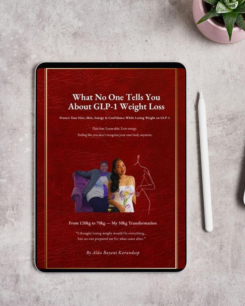 May include: A digital tablet displays a book cover titled "What No One Tells You About GLP-1 Weight Loss." The cover is red with gold accents and includes text about weight loss, hair, skin, and energy. A stylus and a small plant are visible.