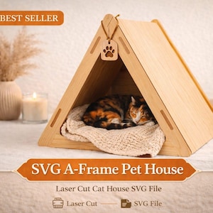 May include: A-frame cat house made of light wood, with a sleeping cat inside on a cream-colored blanket. The house has a paw print cutout and the text "SVG A-Frame Pet House". A candle and vase are in the background.