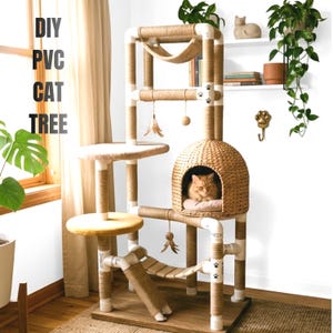 May include: A DIY PVC cat tree with multiple levels, platforms, and a hammock. The structure is made of white PVC pipes wrapped in natural rope. A cat rests inside a woven dome. The text "DIY PVC CAT TREE" is visible.