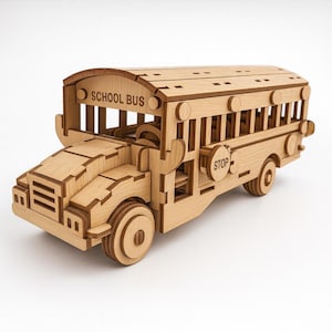 May include: A wooden school bus model with the words "SCHOOL BUS" on the front. The model is made of light-colored wood and features detailed cutouts for windows, wheels, and other components. A "STOP" sign is visible on the side.