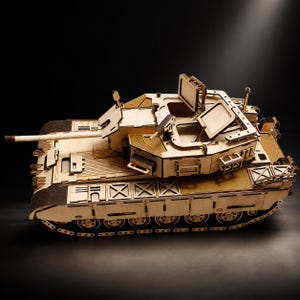 May include: A detailed scale model of a military tank constructed from light-coloured laser-cut wood. The model features a rotating turret with a long barrel, open hatches on the top, and intricate track detailing along the sides of the vehicle body.