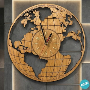 May include: A wooden wall clock with a world map design. The clock face is circular with gold-colored Roman numerals and black hands. The clock's outer frame is a detailed cutout of the Earth's continents and grid lines.