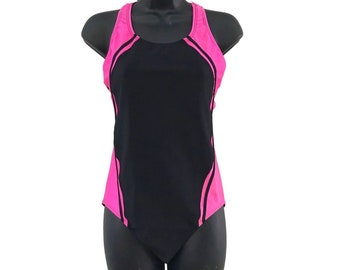 May include: A black and pink one-piece swimsuit with a racerback style. The swimsuit has black trim and a pink accent.
