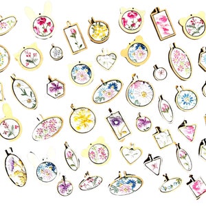 May include: Assortment of embroidery hoops with various floral and geometric designs. The hoops are made of wood and have a natural finish. They are perfect for crafting and creating unique home decor.