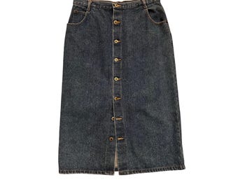 May include: A dark wash denim skirt with a button-down front closure. The skirt has a classic five-pocket design and a knee-length hemline. The buttons are a brass color.