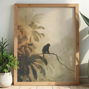 May include: A rectangular wall art print in a light-toned wooden frame featuring a dark silhouette of a monkey perched on a thin branch amidst large, muted green and beige tropical leaves in a soft, hazy, and atmospheric jungle setting.