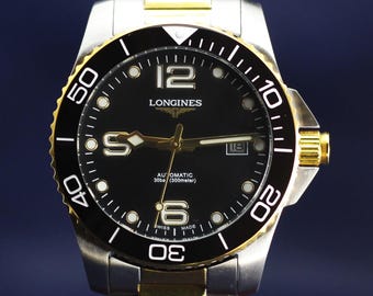 Reloj Longines automático reacondicionado para hombre con esfera negra e indicador de fecha.