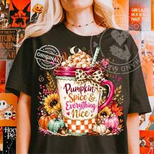 May include: A black t-shirt featuring a graphic of a large mug filled with whipped cream and marshmallows. The mug is decorated with a leopard print bow and the text Pumpkin Spice & Everything Nice, surrounded by sunflowers, pumpkins, and autumn leaves.