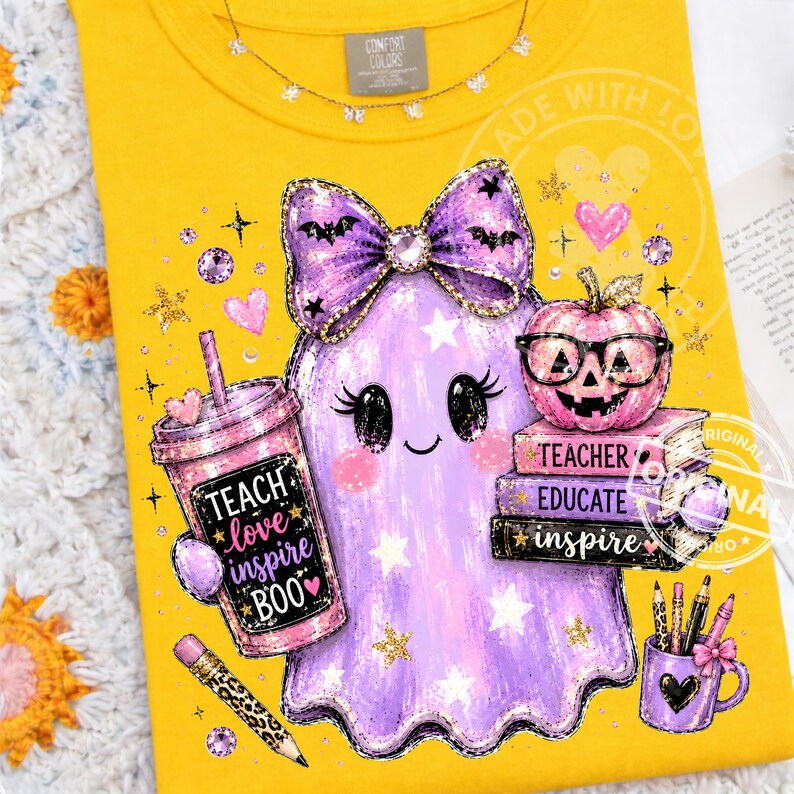May include: A bright yellow t-shirt featuring a graphic of a purple ghost wearing a large bow, a pink tumbler with the text "TEACH love inspire BOO", a stack of books labeled "TEACH EDUCATE INSPIRE", a pumpkin with glasses, and a pencil.