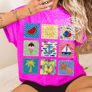 May include: A bright pink t-shirt featuring nine colorful square patches with summer-themed designs. Patches include a watermelon slice, sun, beach ball, ice cream cone, anchor, sailboat, palm tree, flip-flops, and starfish.