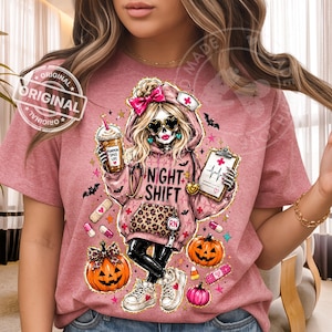 May include: A mauve t-shirt featuring a skeleton nurse with heart-shaped sunglasses, a pink bow, and the words "NIGHT SHIFT." The design includes pumpkins, bats, and medical supplies. The shirt also has the text "PUMPKIN SPICE LIFE."
