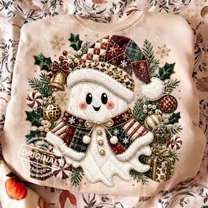 May include: A light beige sweatshirt featuring a central graphic of a white ghost wearing a Santa hat with a leopard print trim. The ghost is surrounded by Christmas ornaments, holly, pine branches, and gift boxes in red, green, and gold tones.
