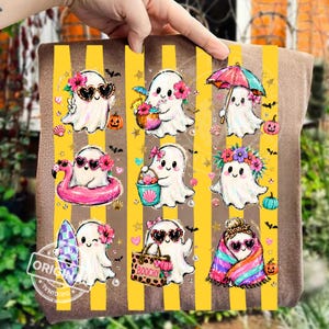 May include: A brown fabric item featuring a yellow striped background with nine illustrations of white ghosts. The ghosts are depicted with various accessories including heart-shaped sunglasses, floral crowns, a pink flamingo float, a beach bag, and a colourful umbrella.