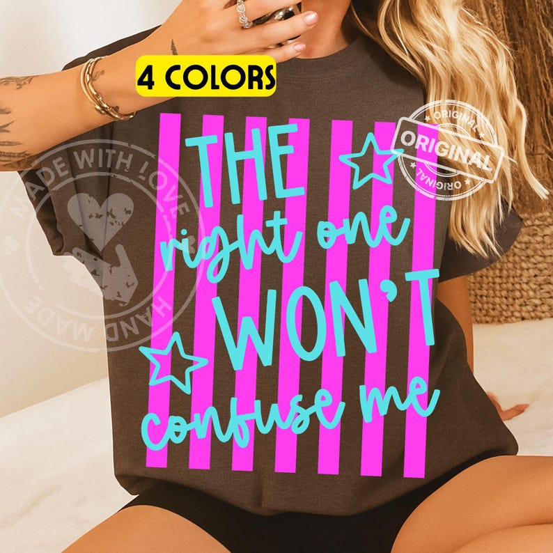 May include: Dark gray t-shirt with the text "THE right one WON'T confuse me" in turquoise, set against vertical pink stripes. The shirt also features a yellow box that says "4 COLORS" and a white "ORIGINAL" stamp.
