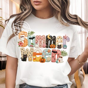 May include: White t-shirt with the words "Summer Ween" in colorful, patterned letters. The design includes Halloween and summer-themed graphics like pumpkins, bats, and seashells. A playful and festive design.