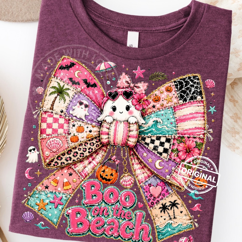 May include: A purple t-shirt featuring a colorful graphic of a ghost wearing heart-shaped sunglasses, with a patchwork bow design. The text "Boo on the Beach" is displayed in pink, with Halloween and beach-themed illustrations.
