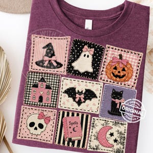 May include: A purple t-shirt with a patchwork design of Halloween-themed images. The patches include a witch's hat, ghost, pumpkin, haunted house, bat, black cat, skull, spell book, and crescent moon. Each patch is outlined with stitching.