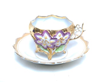 Antique German Iridescent Porcelain Teacup and Saucer Raised Purple Flowers Flower Shaped Handle