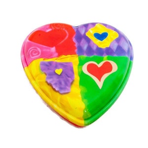 May include: A heart-shaped trinket box with a vibrant patchwork design. The box is divided into four sections, each with a different colour and pattern, including red, purple, yellow, and green. Each section features a heart shape.