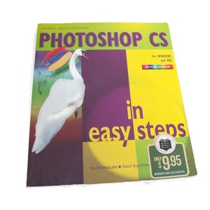 May include: A book titled "Photoshop CS in easy steps" with a white swan illustration. The cover is a mix of yellow, purple, and green. The book is for Windows and Mac, in full colour.