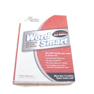 May include: A copy of "Word Smart" by The Princeton Review, 3rd Edition. The book cover is white with red and silver accents, featuring the title in large, bold letters. The cover also includes text about vocabulary building and standardized tests.