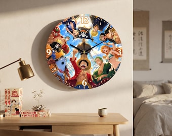 May include: A round wall clock featuring a colorful graphic illustration of the One Piece anime crew. The design includes characters like Luffy, Zoro, and Nami arranged in a circle around the center. It has black clock hands and white numbers.