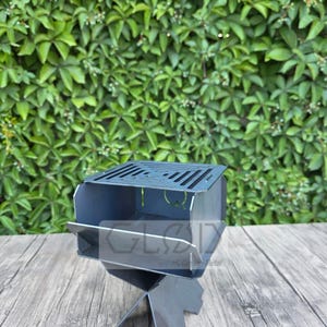 May include: A white ceramic mug with a black handle and the text "But First, Coffee" in a black, bold font. The mug is sitting on a wooden surface. The mug is approximately 4 inches tall.