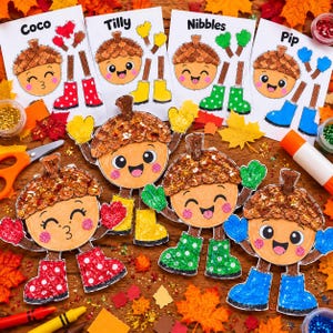 May include: A set of four paper acorn characters named Coco, Tilly, Nibbles, and Pip, each featuring glittery caps, colorful mittens, and patterned boots. The characters are displayed alongside matching paper templates, scissors, and glue sticks.