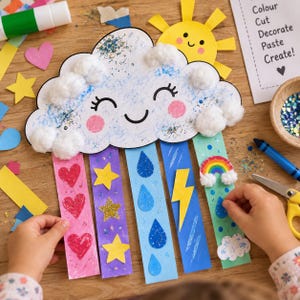 Op de afbeelding: Een papieren knutselproject met een lachende witte wolk versierd met watjes, glitters en roze wangen. Een gele zon bevindt zich erboven, terwijl eronder vijf kleurrijke papieren stroken hangen, versierd met rode harten, gele sterren, blauwe regendruppels, een bliksemschicht en een regenboog.