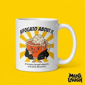 May include: White ceramic mug with the phrase "AFFOGATO ABOUT IT" and a cartoon affogato design. The design features an orange cup with a scoop of ice cream, a face, and the text "(it means forget about it. and also dessert.)".