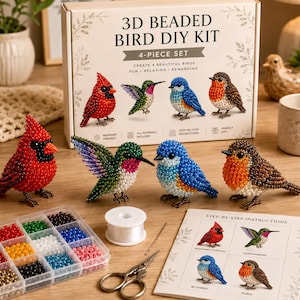 May include: A 3D beaded bird DIY kit featuring a box with four bird models: a red cardinal, a green hummingbird, a blue bird, and a brown robin. Includes a plastic bead organizer, white thread, a needle, scissors, and an instruction sheet.