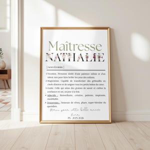 May include: A framed print with the text "Ma&icirc;tresse Nathalie" in a decorative font, with floral accents. The print includes a definition and adjectives in French, with the text "Merci pour cette belle ann&eacute;e" and the signature "Nina".