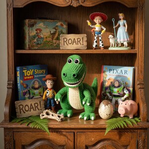 May include: A wooden cabinet displays Toy Story themed items. A green crocheted dinosaur, figurines of Woody and Jessie, and a vintage lunchbox are visible. Books and a piggy bank are also on display. The word "ROAR!" is on a wooden sign.