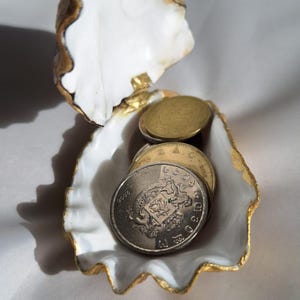 May include: A rustic wooden sign with the text "Welcome to our home" in white lettering. The sign features a distressed finish and a simple, inviting design, perfect for entryway decor.