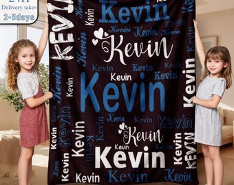 May include: A dark brown fleece blanket featuring the name Kevin printed repeatedly in various sizes, fonts, and shades of blue and white. The design includes small heart icons interspersed among the text, creating a repeating pattern.