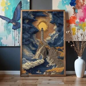 May include: A framed art print depicts a lighthouse on a cliff, with a sunburst in the sky. The artwork features a textured, three-dimensional effect, with shades of blue, yellow, and brown. The frame is a warm, natural wood tone.
