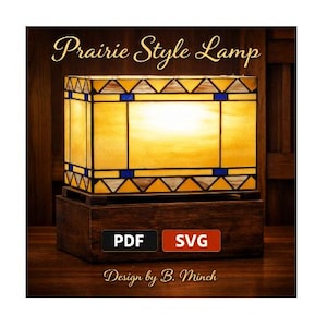 May include: A Prairie Style Lamp design. The lamp features a rectangular shade with yellow glass panels, accented with blue and brown geometric patterns. The base is a dark wooden box. The text "Prairie Style Lamp" and "Design by B. Minch" are visible.