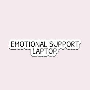 May include: A white sticker with a black border and the words "EMOTIONAL SUPPORT LAPTOP" in a bold, sans-serif font. The sticker has a wavy, irregular edge, and is set against a pale pink background.