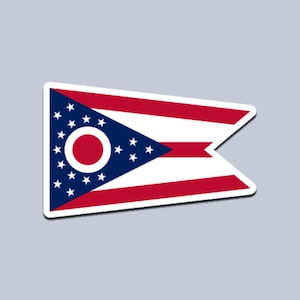May include: A sticker featuring the flag of Ohio. The flag has a triangular blue field with white stars and a red circle in the center. The flag also has red and white stripes.